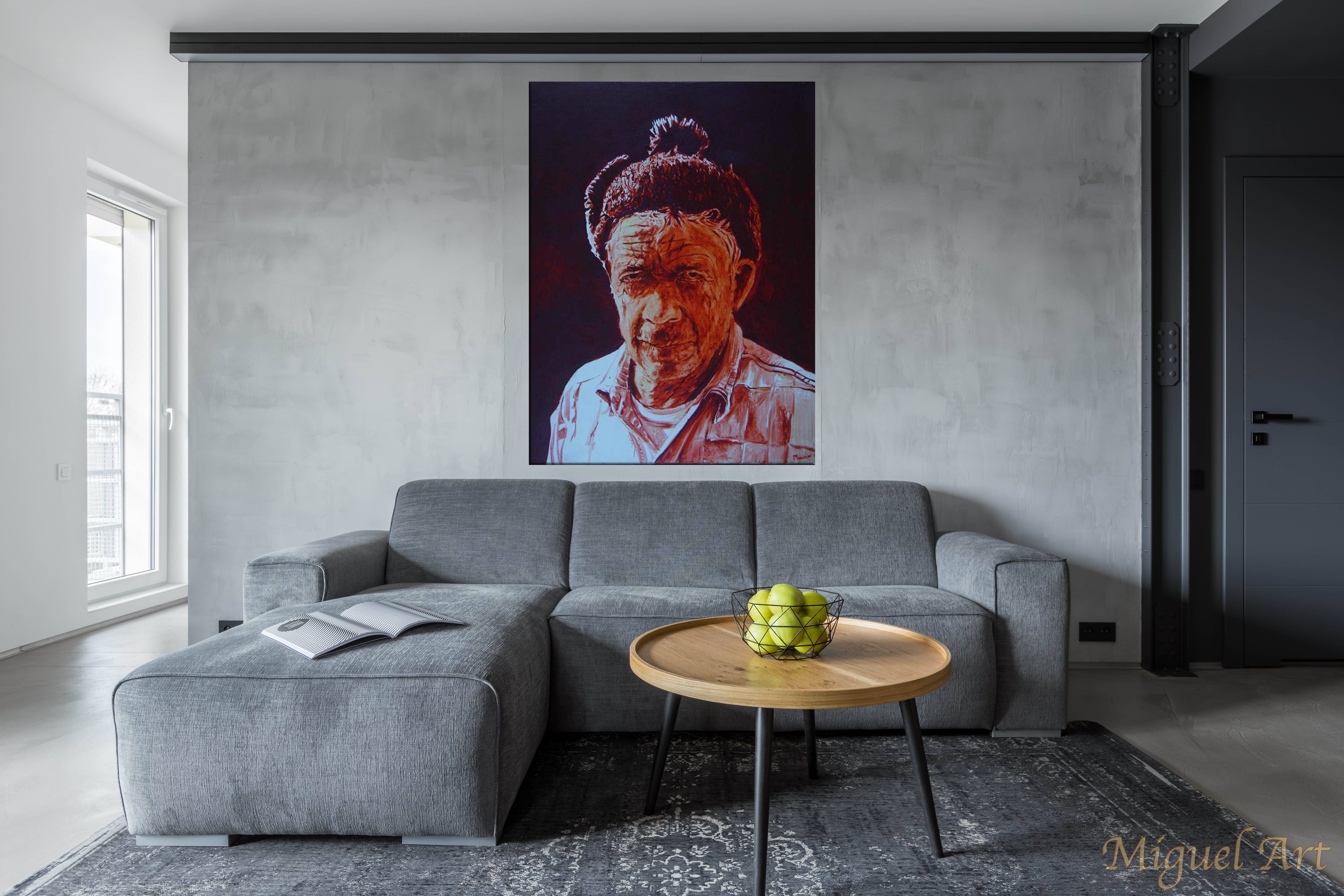 Painting of Santana displayed on the wall above a grey couch