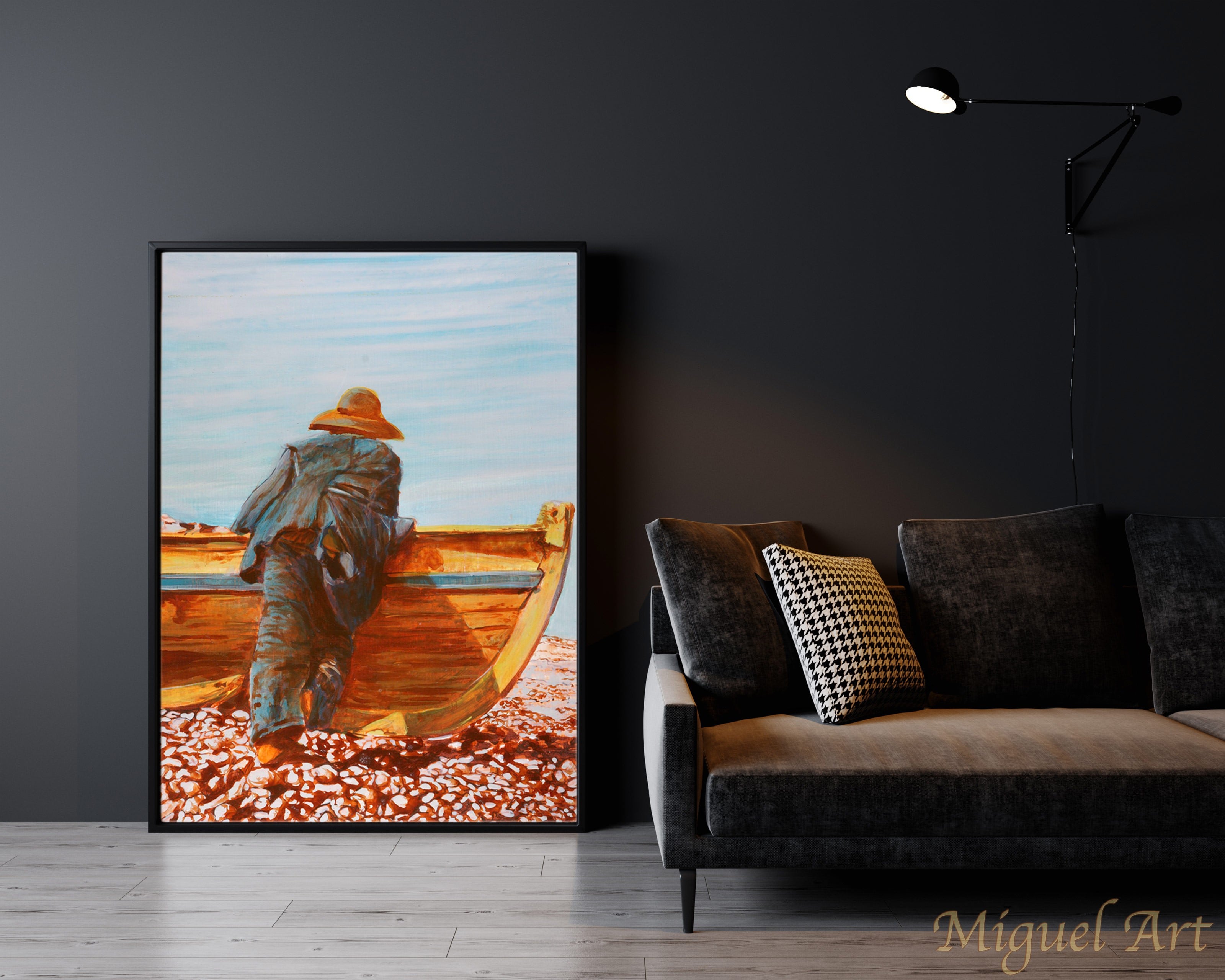 Painting of Pescador displayed leaning against the wall on the floor next to a black couch